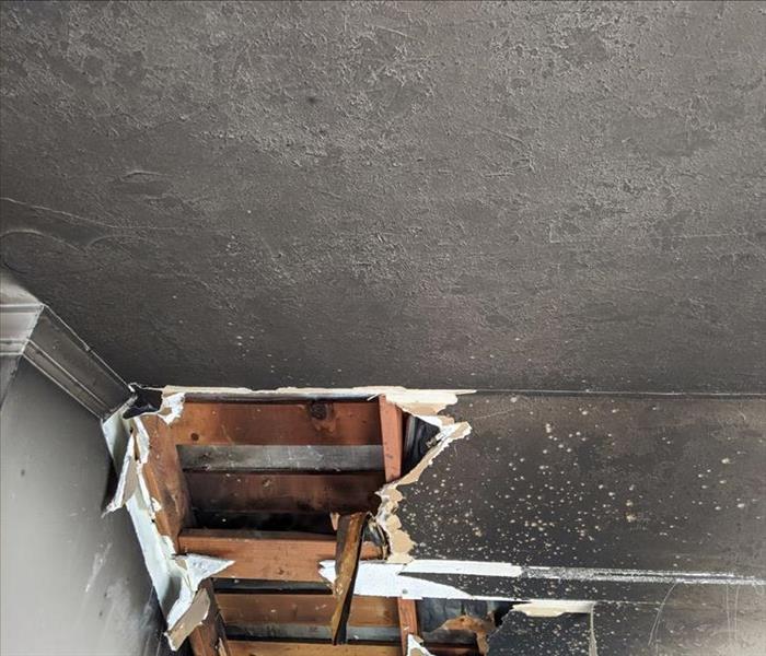  A ceiling filled with black smoke and soot damage. 