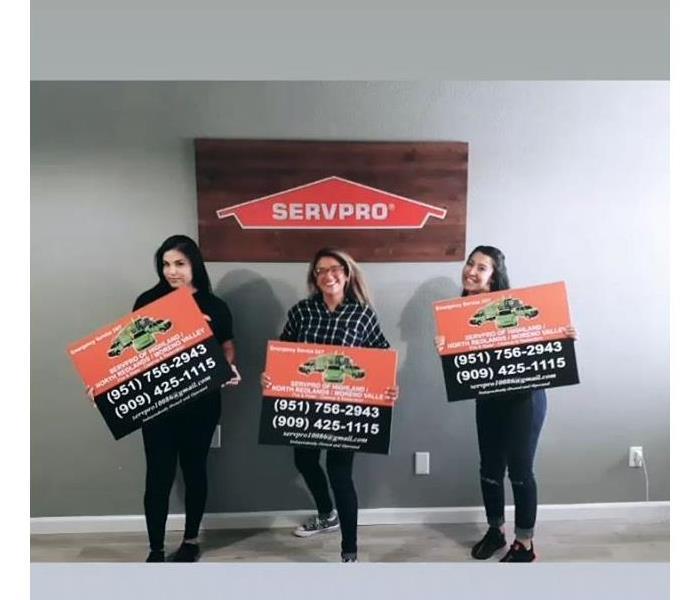 The ladies of the office holding our new SERVPRO lawn signs